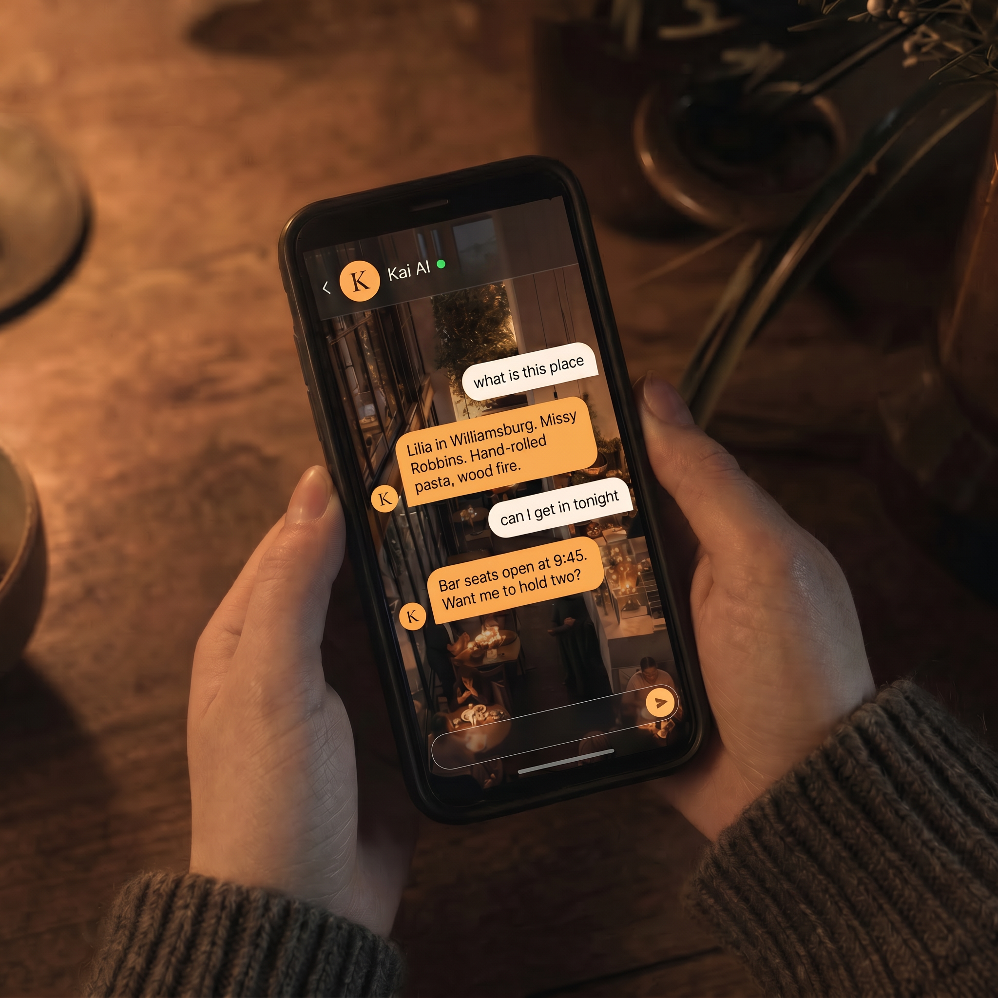 A warm, dimly lit restaurant viewed through the Savrli App on a phone held above a wooden table.